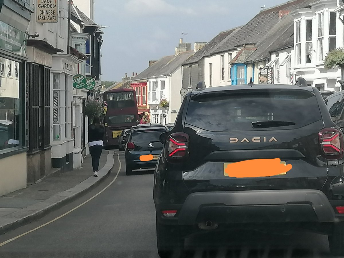 AVOID Helston town centre right now. A van parked out of the box near the Meneage Street zebra crossing means the double decker bus can't get past and the whole town is at a standstill. (And if you are the van driver please come back and move it!)