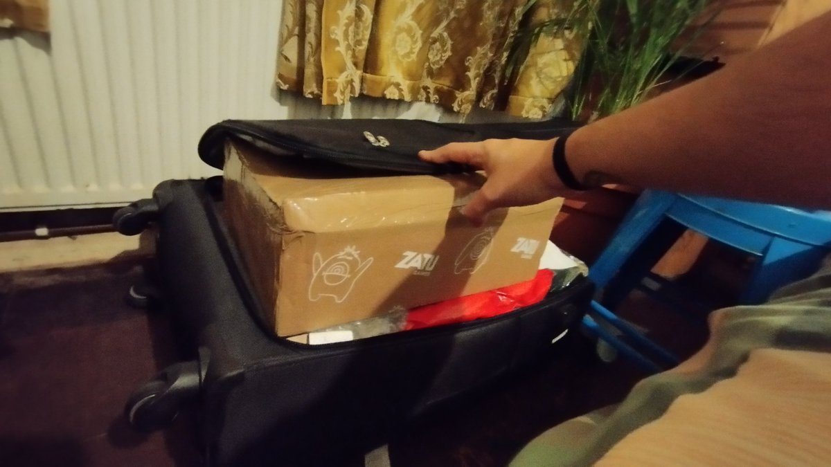 Last minute board game delivery package poses some problems in a full suitcase...