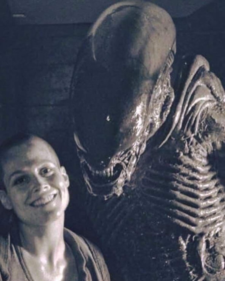 A behind the scenes photo of Sigourney Weaver on the set of ALIEN³ (1992).