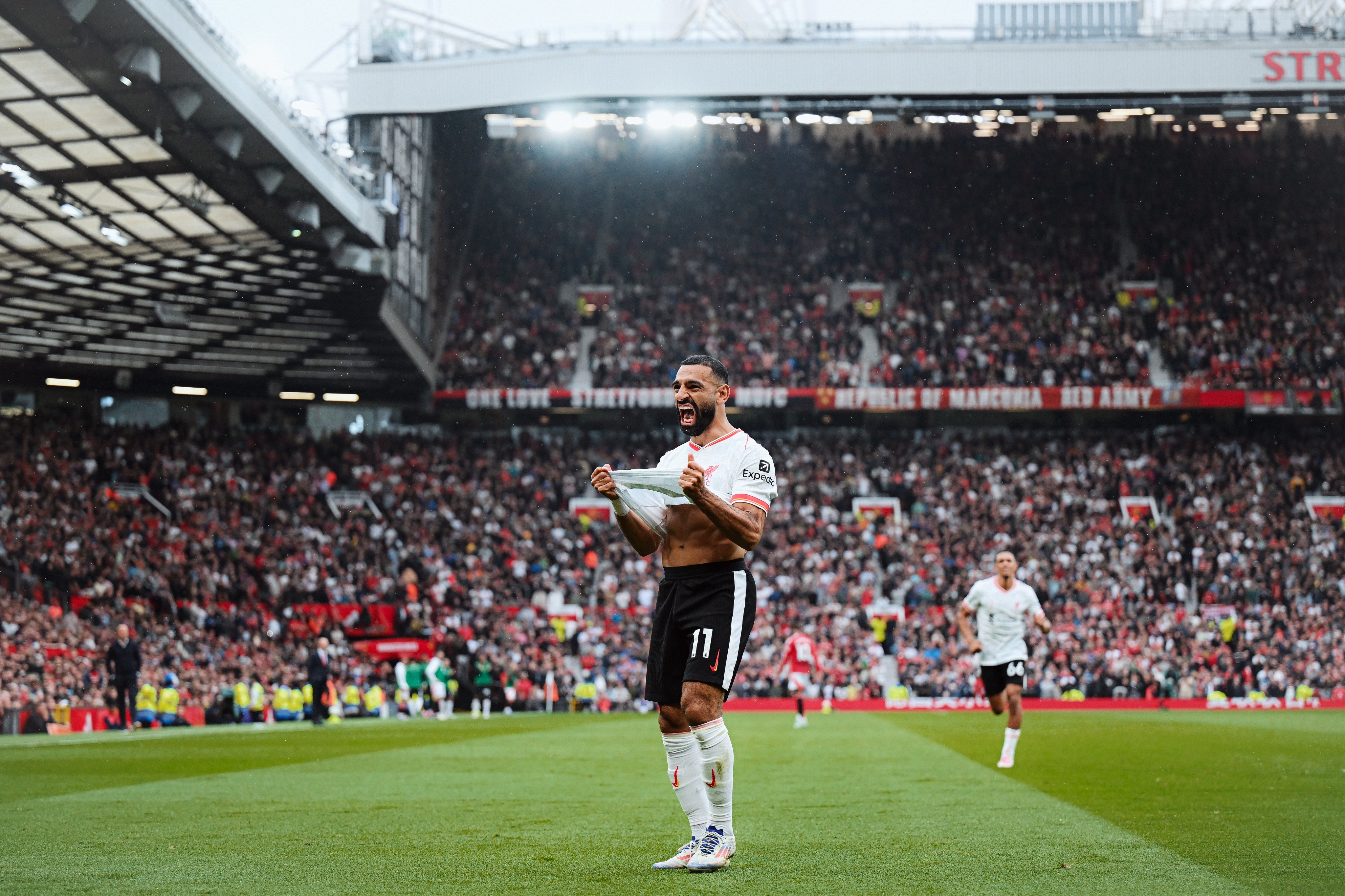 Photography of Mo Salah celebrating his goal against Manchester United.