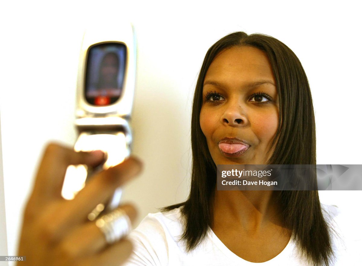 shitbritishpics's tweet photo. British pop star Samantha Mumba plays with the new Vodafone digital camera mobile phone during a promotional  photoshoot in London (2002) https://t.co/KO7lAL1SKk