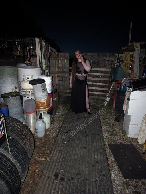 A beautiful black gown, black and red corset heels, and a scrapyard. Gorgeous.  Full set available on