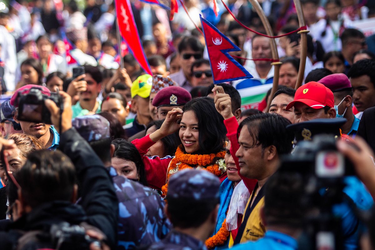 @paleshagoverdhan__ 

Palesha Goverdhan, a 21-year-old para- taekwondo athlete and coach Kabiraj Negi Lama gestures to fans upon their arrival after winning a first historic bronze medal for Nepal at the Paris Paralympics 2024 at Tribhuvan International Airport in Kathmandu