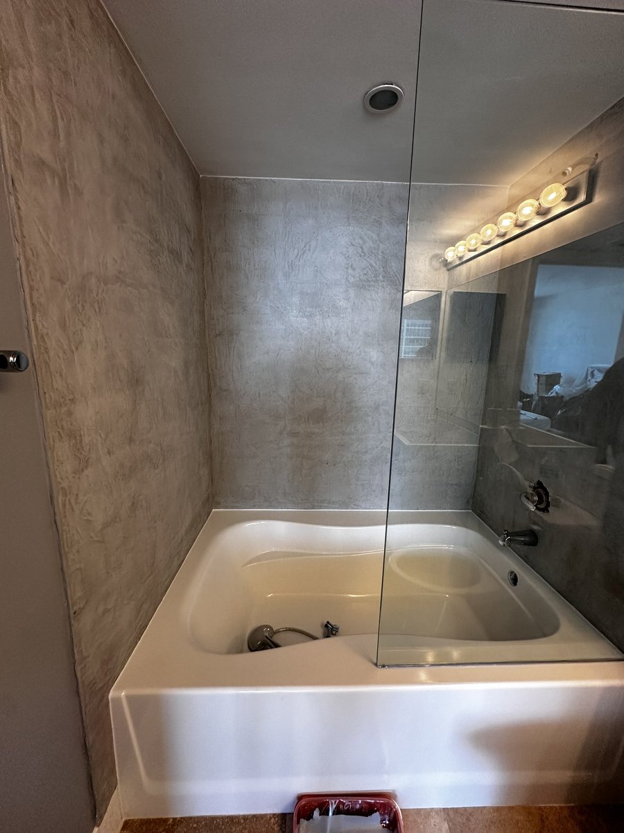 KoncreteArt's tweet photo. Looking for a way to avoid demo but still update your bathroom? Look no further! These concrete wall overlays are applied right over tile and eliminate the need for grout joints, making it easier and quicker to clean! https://t.co/arlAAxDvB8