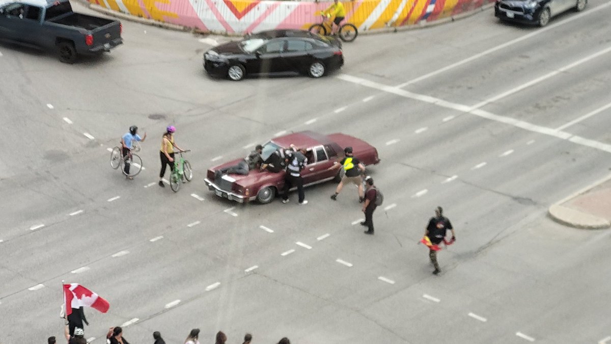 CraigHebert's tweet image. I watched this idiot hit people with his car on purpose. This is (one of) my own photos. It's bullshit that people are trying to make excuses for this driver. You can see other drivers &amp;amp; a cyclist correctly avoiding the protest. This was intentional violence.