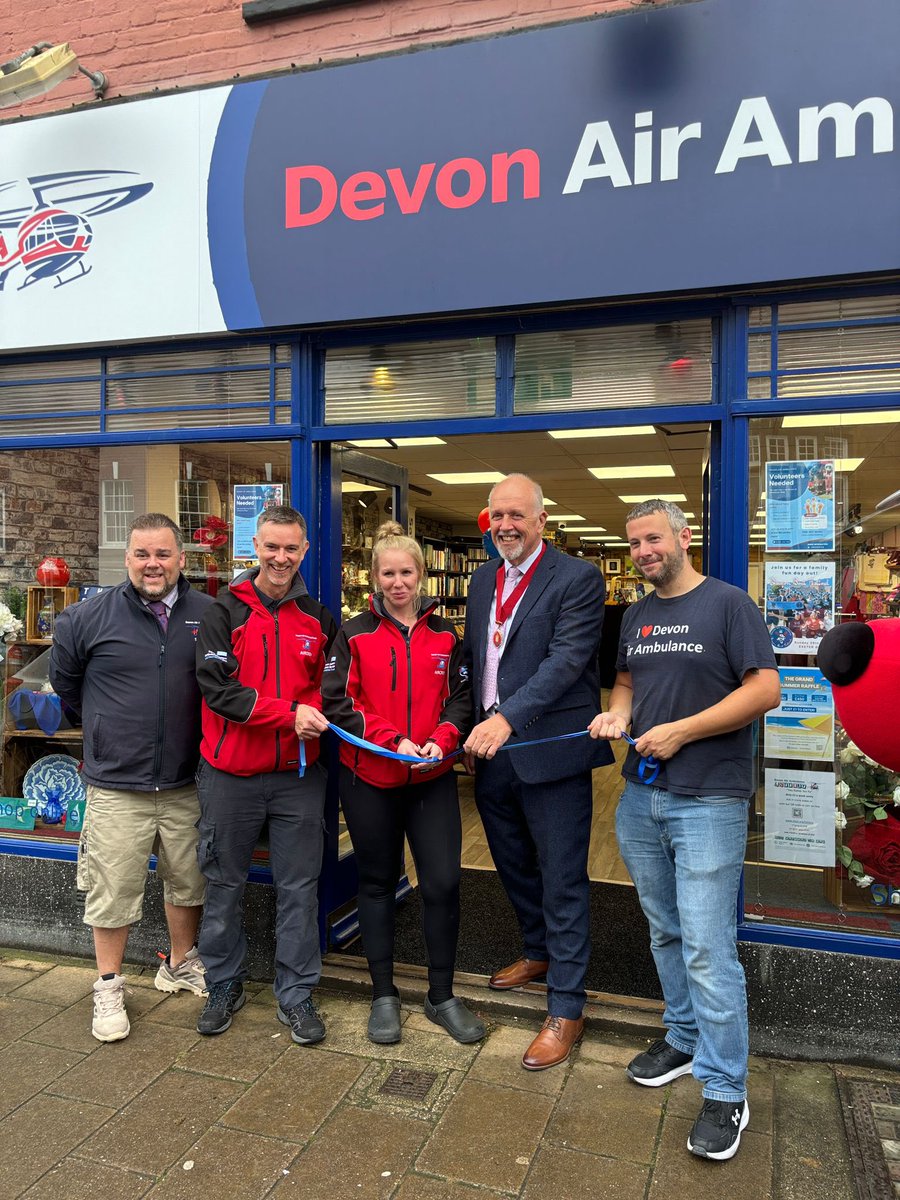 DevonAirAmb's tweet photo. The ribbon has been cut and our brand new shop is open on Crediton High Street! Huge thanks to Deputy Mayor, Cllr Steve Huxtable who came along to help celebrate the occasion. We were also joined by two of our Critical Care Paramedics Jessica Thomas-Mourne and Mark Hawley! https://t.co/mQvfTYOyQE