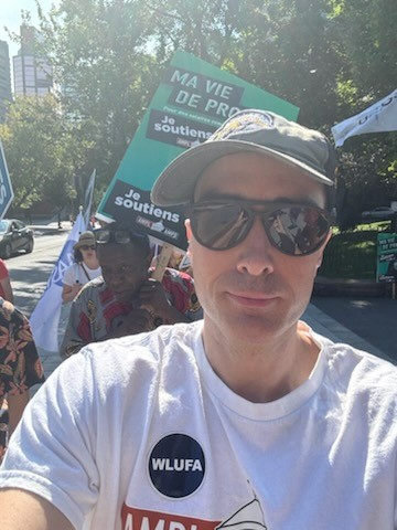 WLUFA's tweet image. For the 3rd time, WLUFA’s @CautFund Rep Cameron McKenzie joins the flying picket with @AMPL_AMPD. Support from across Canada grows! Faculty unions are essential to higher ED’s mission—and they’re under threat. #Solidarity #firstcontract #Solidarite @CAUT_ACPPU @OCUFA