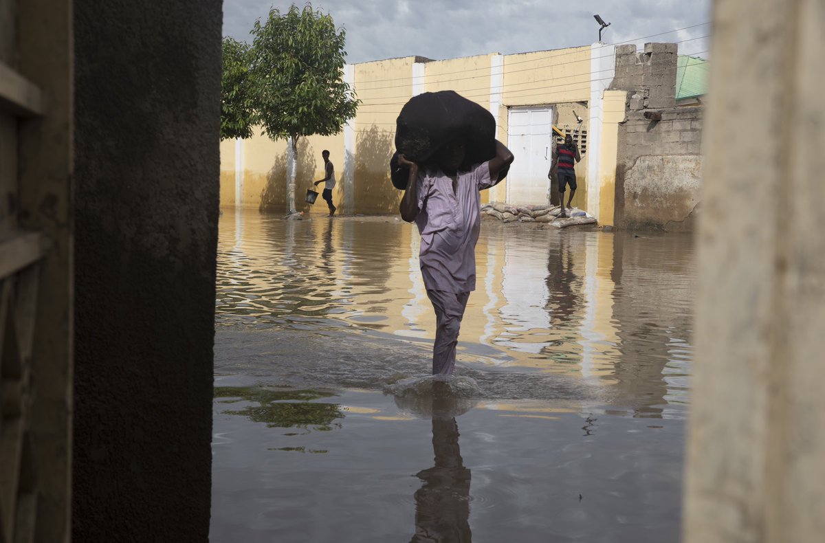 The aftermath of the flood. In Kofa biyu, Maiduguri, while the flood is stagnant, people are arriving to retrieve clothes and return to their temporary shelters in other places.