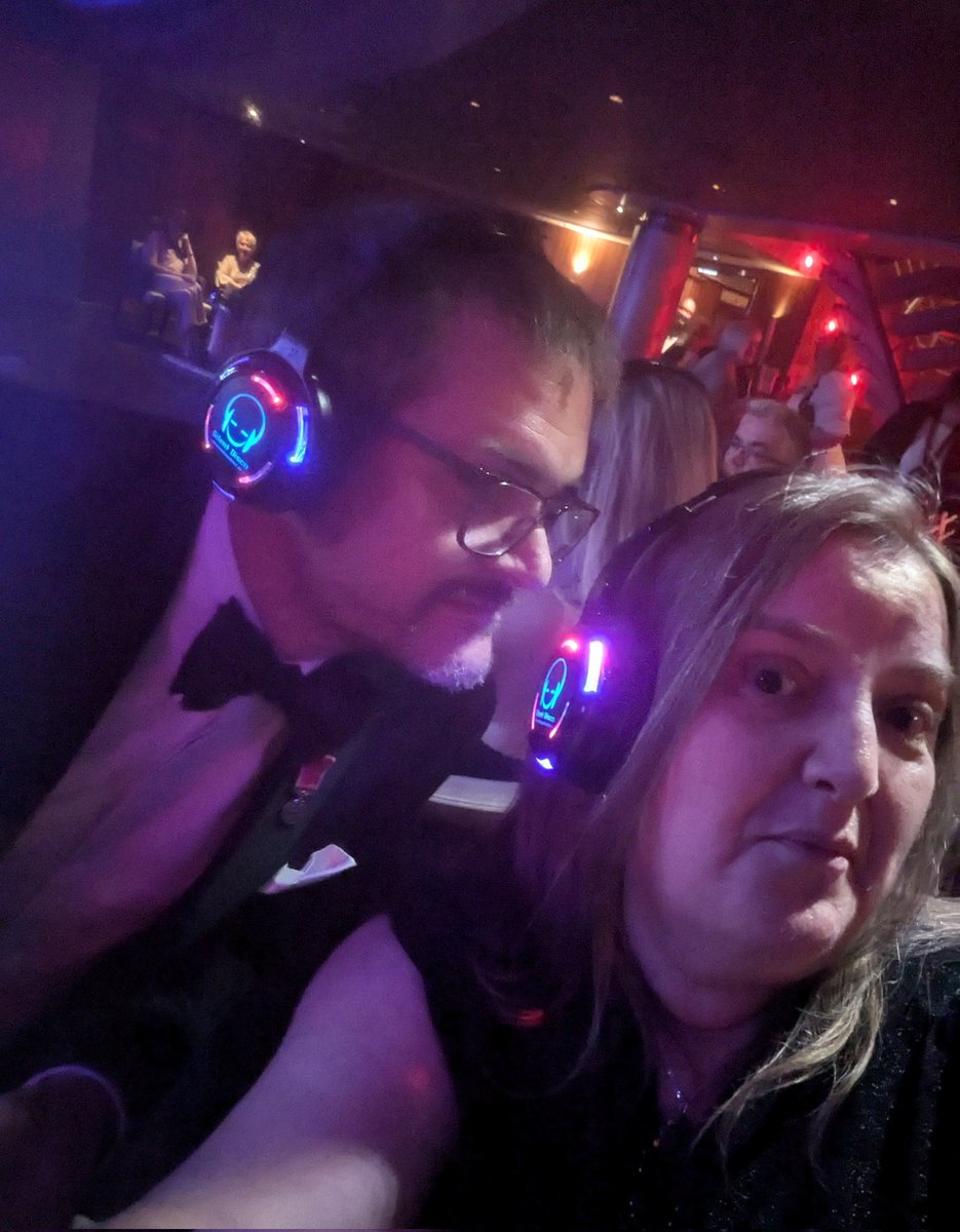 Cruisecred's tweet photo. Hands up if you love a Silent Disco 🕺🪩 I think Mr @L2Cruise is smelling my 🎧 😂🚢#cruise #partytime #formalnight #QM2 #Cunard #SilentDisco https://t.co/GBj8TO388c