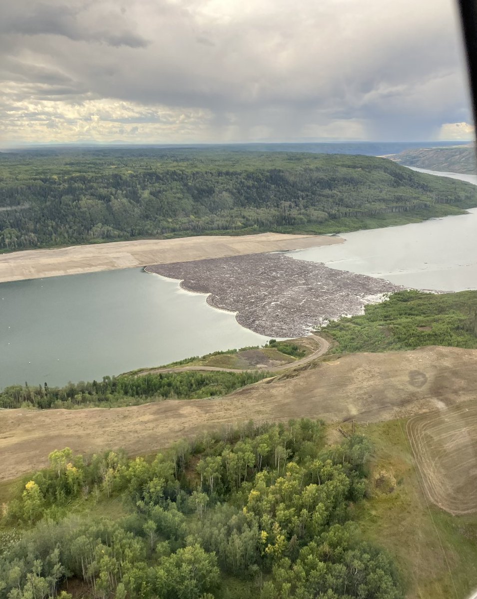 Here's a photo of the debris just above the #SiteC dam on September 3, held back by a boom. Was this boom deliberately let go, for whatever reason, or did it break? They spent a bunch of our money building huge concrete anchors to hold it.
