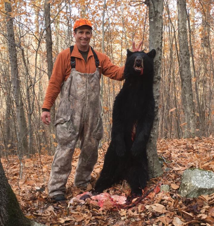 NHCART's tweet image. They claim they respect wildlife, yet their actions are anything but respectful. 
Here the bear killer does rabbit ears as a joke behind the bear&apos;s head. The bear is strung up like a lynched corpse.
Where is the respect? We don&apos;t see it.
#CompassionOverKilling