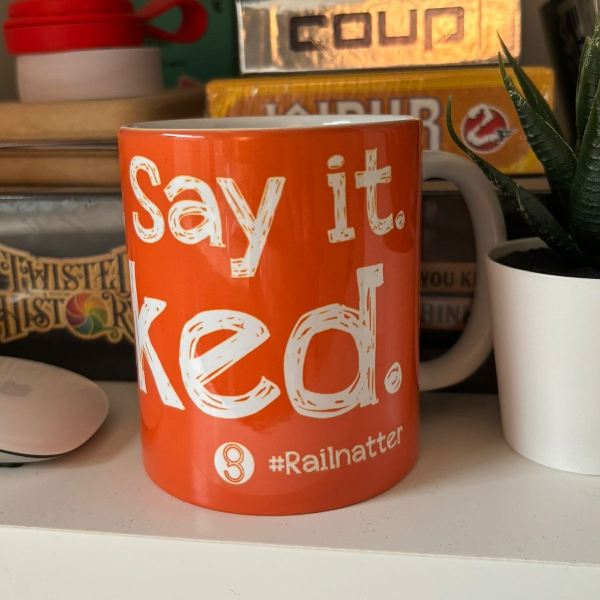 it's the other side of the same mug, on a shelf surrounded by board games and books