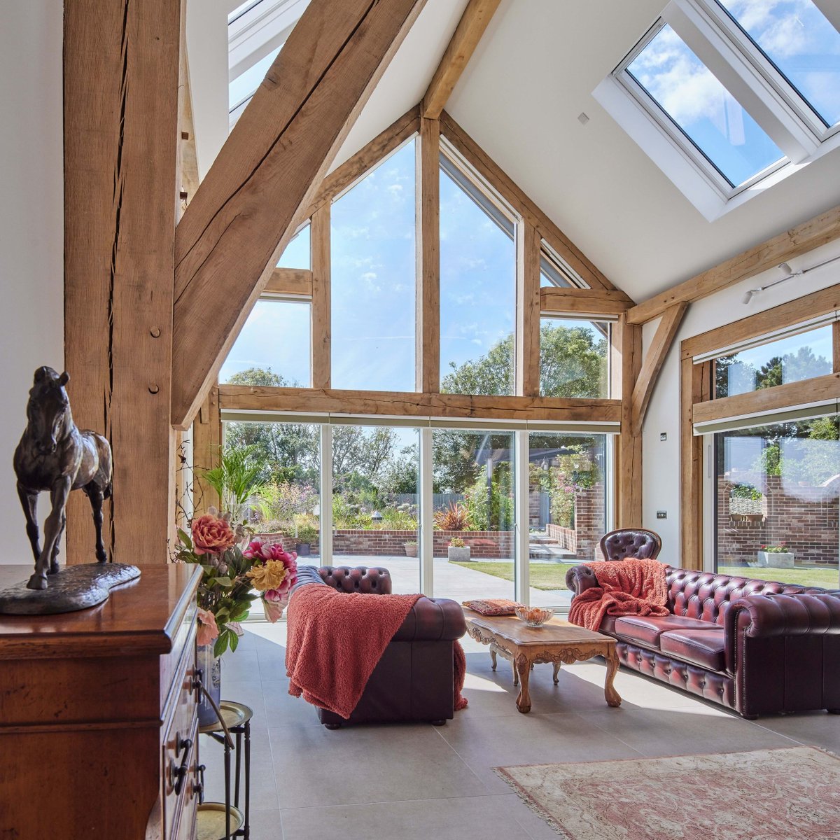 Two-storey oak-framed home featuring vaulted ceilings that create an airy and open atmosphere. The interior is a perfect blend of rustic charm and modern living, with exposed wooden beams and an open-plan layout. 
⁠
Architectural Services by Carpenter Oak