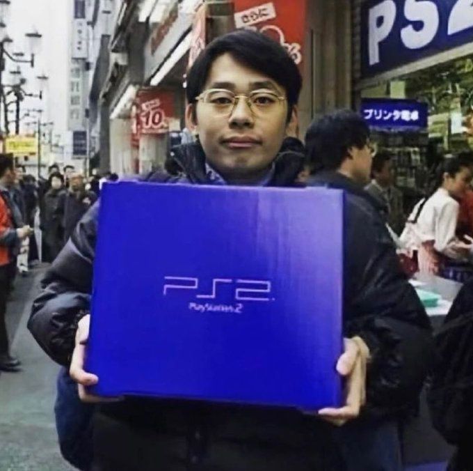 A Japanese man shows his newly acquired PS2 on Japan's launch day. March 4, 2000.