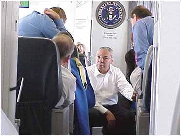 Secretary of State Colin Powell boards a plane in Lima, Peru, heading to  Washington, D.C.