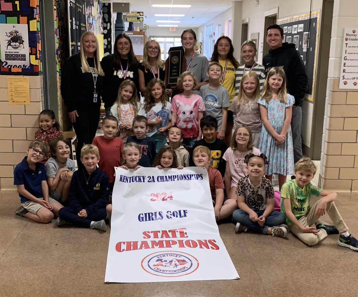 MurrayTigers's tweet photo. Our 2A State Golf Champions, Coach Payton Knight, Emerson Vaughn, Grey Martin, Macy Saylor, Riley Morris, Greer Miller and Coach Austin Knight taking a picture with Payton’s 2nd Grade class!!!  Once again… CONGRATULATIONS! https://t.co/ChjKfOpFB7