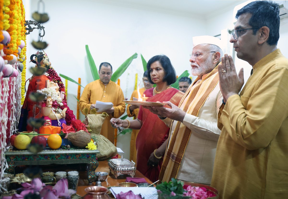 BJP4India's tweet photo. Captivating moments captured at the residence of Chief Justice of India, Justice DY Chandrachud, as Prime Minister Modi graciously participates in Ganesh Pooja. https://t.co/bj3xBvCbjs