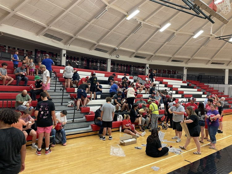 EHS Football families help put decals on the players' helmets. Our families' support is a difference maker! #PartOfThePride