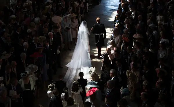 MeghansMole's tweet photo. I’ve never seen this photograph of Prince Harry &amp; Meghan Markle exiting the Chapel on their wedding day ( not 3 days before)

This photo symbolizes Harry’s married life 

Full of darkness &amp; unhappiness https://t.co/G5PGy3jiql