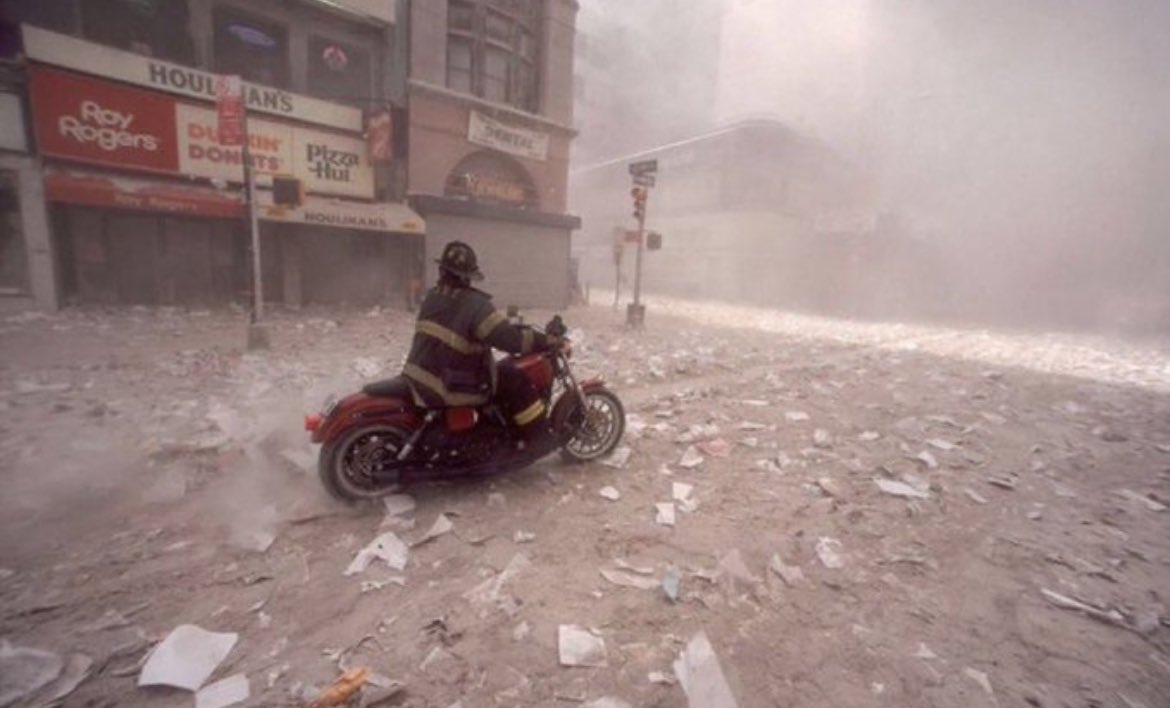 25. FDNY Firefighter Tim Duffy speeds to Ground Zero on his Harley motorcycle to join his firehouse comrades. Despite being off duty on 9/11, he rushed to the station, grabbed his gear, and headed in.