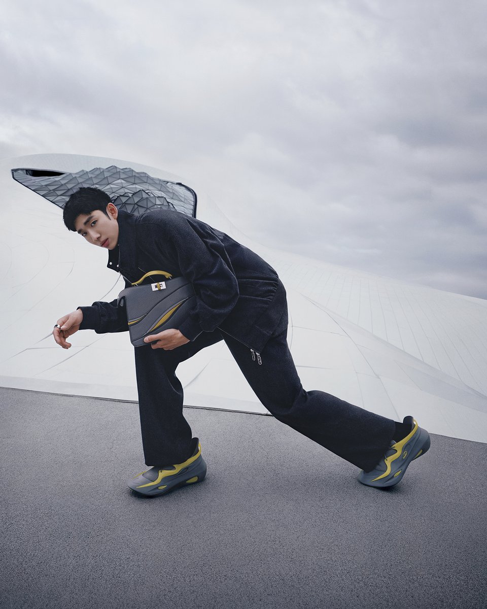Fendi's tweet photo. Short-track speed skater Lin Xiaojun wore the #FendiPeekaboo and sneaker created with MAD Architects and their founding partner Ma Yansong for #FendiFW24. Lin was photographed on the Harbin Grand Theatre designed by MAD. https://t.co/O2XXGtVYwP