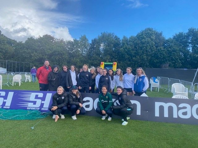During a trip to Stormont, a group of girls went to watch the Ireland vs. England cricket match. They were fortunate enough to take a photo with some Irish players while waiting for the game to begin.