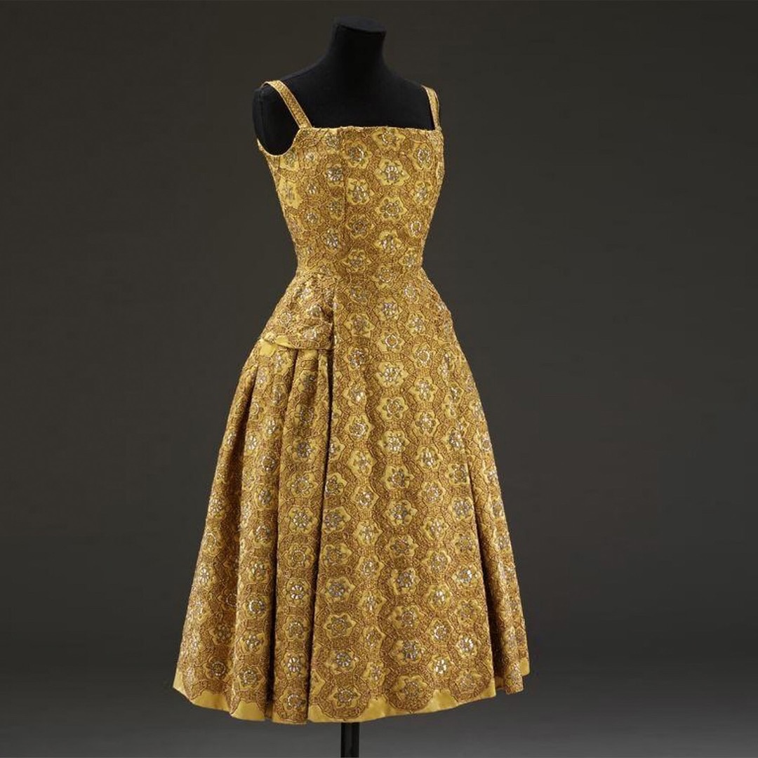 Prou cocktail dress by Christian Dior in 1954.  This dress is from  Christian Dior's controversial H-Line collection for autumn/winter 1954-55.  The H-Line flattened the bust for a sleek, elongated look, which
