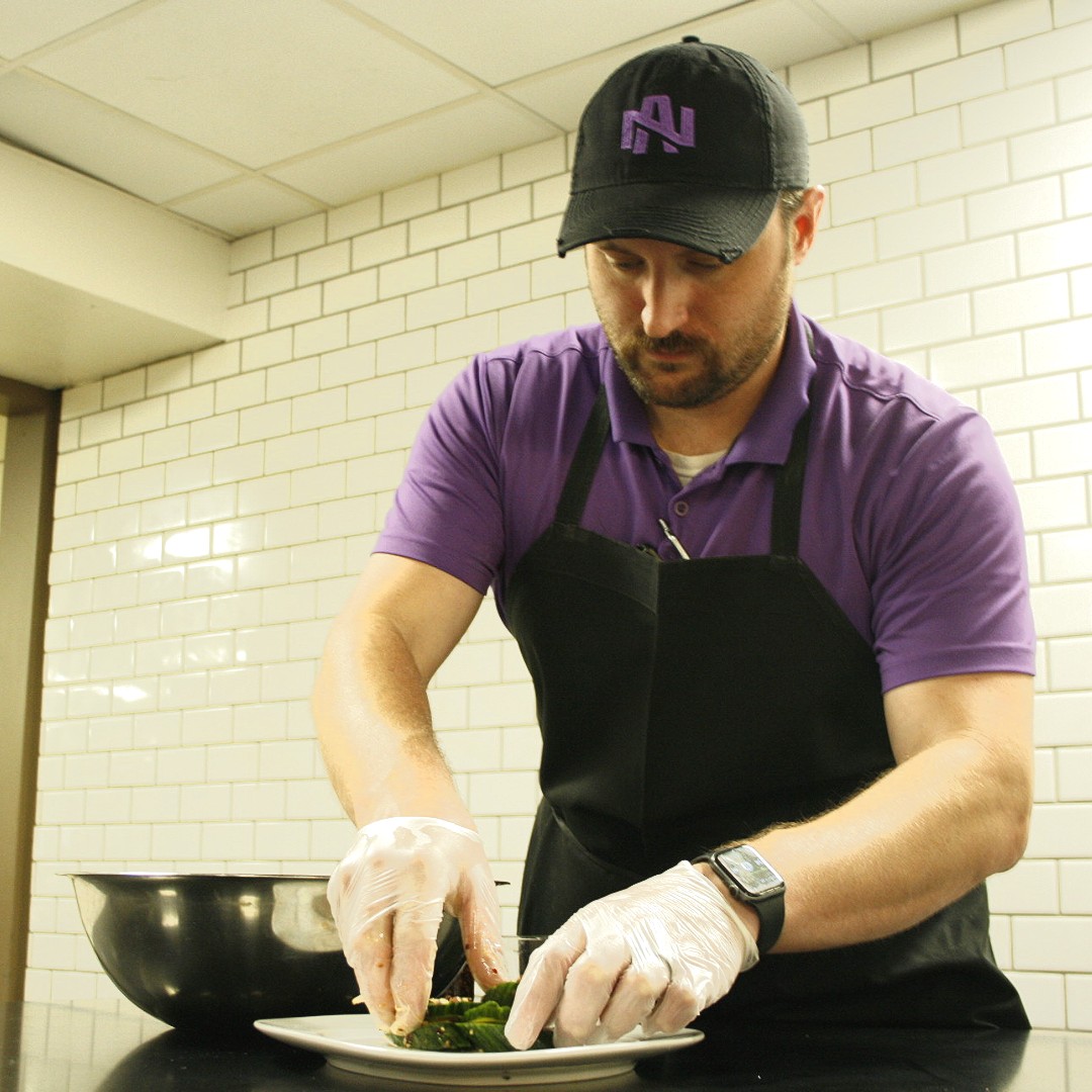 UNA_Dining's tweet photo. Chef Appreciation Week 👨🏻‍🍳

Shown Here: Chef TJ demonstrates his prestigious flare while preparing a chili garlic crisp cucumber salad. Chef TJ Seagraves has been a chef for 15 years and a loyal Chartwells employee for 8 years. 
We appreciate you 💜 💜 💜 
#chefappreciationweek https://t.co/fwdMCLoO1Z