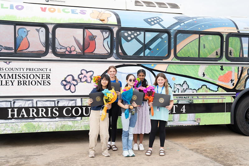 HCPrecinct4's tweet photo. Commissioner Briones unveiled a new bus today featuring artwork from @katyisd McMeans Junior High students! 🚌🎨 The theme was the history and unity in #HarrisCounty, highlighting the diverse perspectives of our vibrant community. #HCPrecinct4 #Community #YouthEngagement https://t.co/3wo3sHliJV