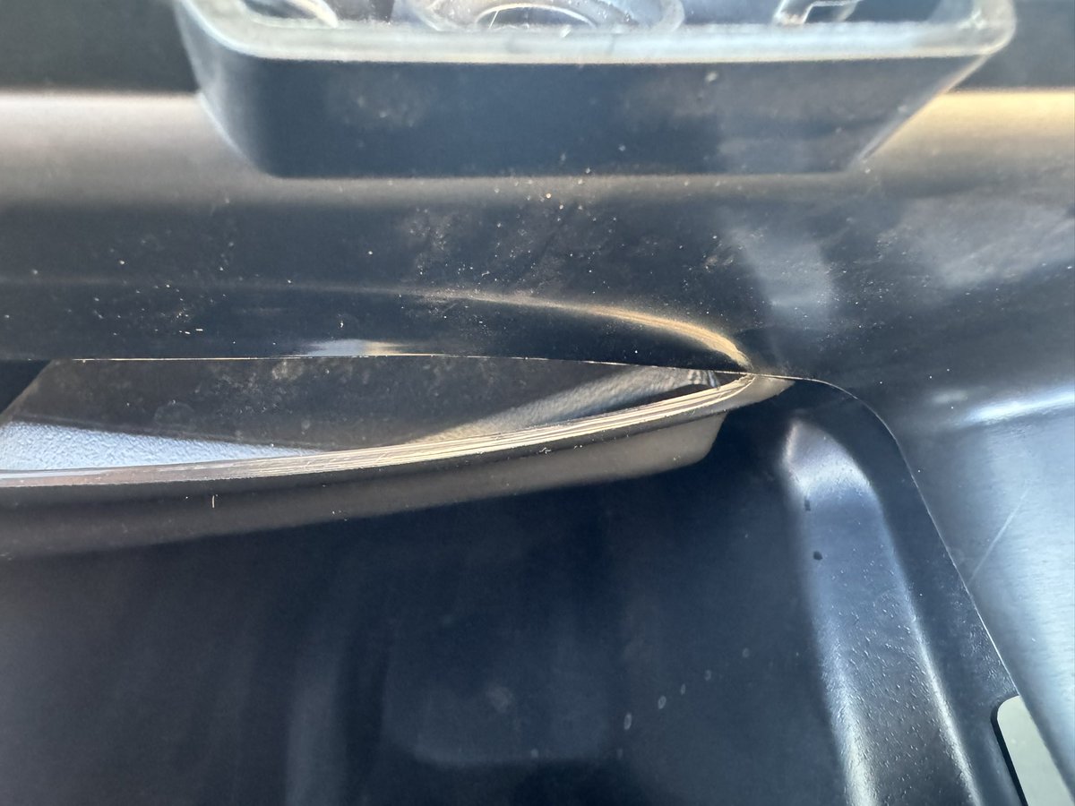 ivioksha's tweet photo. Tried to clear some fallen leaves out from a 2024 Tesla Model 3 Performance delivered exactly a week ago. Shocked that the A/C intake duct wasn’t even installed…  It was let loose there without any signs of effort to proper installation. Please no more surprises🤞@elonmusk https://t.co/3FRLgOM4PD