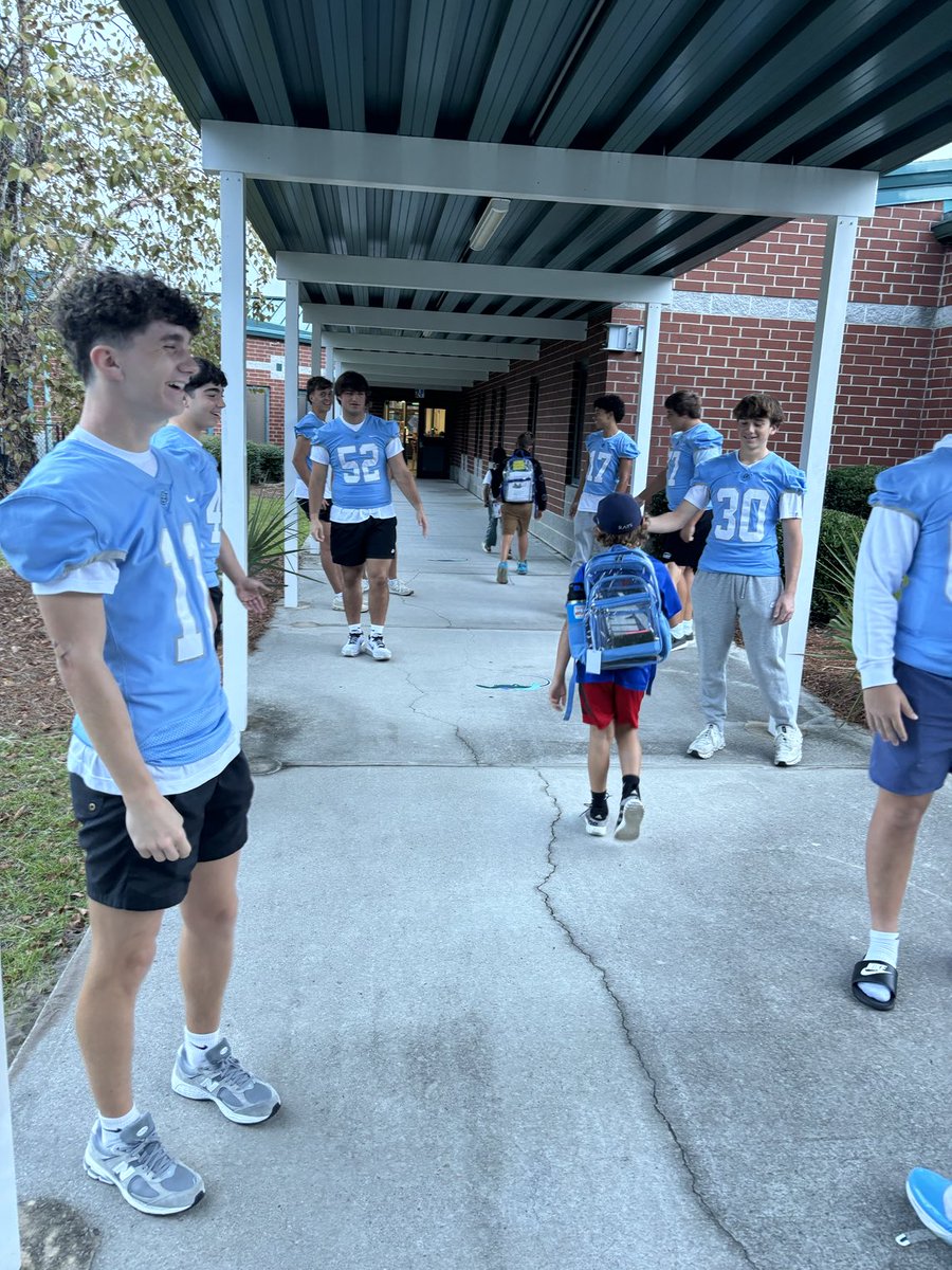 Another group of players and cheerleaders welcoming students to Seaside Elementary #Sharks