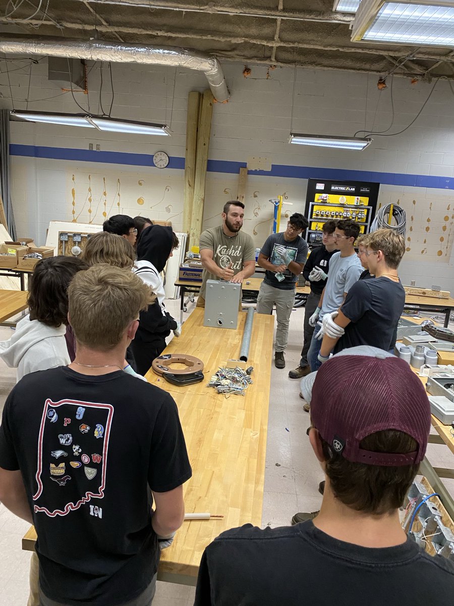Mr. Massey is demonstrating and explaining to his 1st year electrical students the process for bringing electricity from an outside box into a building.