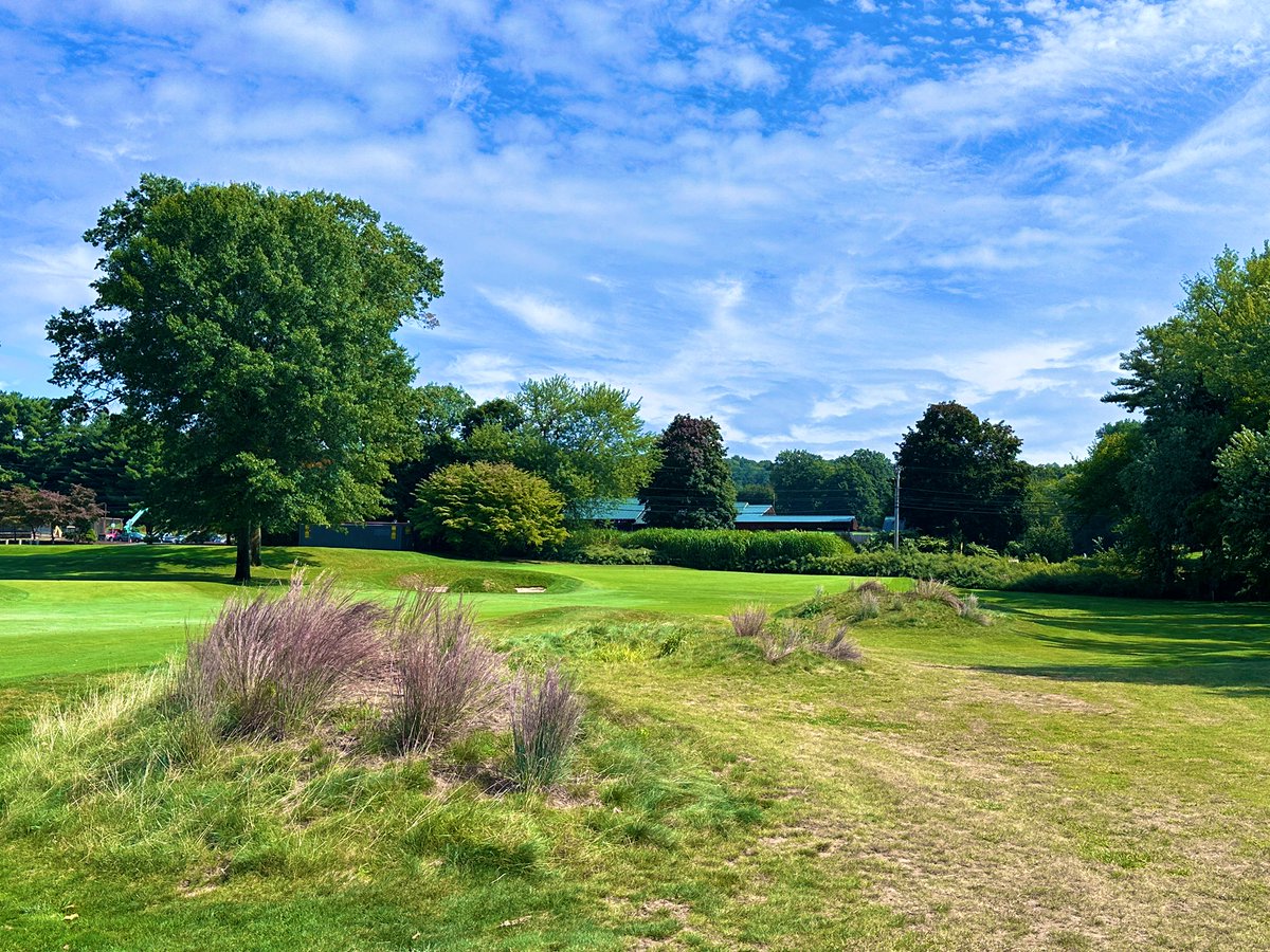 Top100Rick's tweet photo. Country Club of Farmington - 1924
Devereux Emmet 

💎💎💎 HIDDEN GEM ALERT!!! 💎💎💎

I’ve been on an Emmet run lately and he has very quickly ascended my list of must play architects. His courses, when properly maintained, are as fun and quirky as you will find. 

CCF is a true throwback club. It has all the qualities you find in a club that defends its roots. The classic, wood floored and paneled lounge. The classic patio overlooking 1 and 18. The quirky short par 4 starter and long par 3 finisher. The wild greens. It’s so good. 

The highlight are the greens, which are DIABOLICAL! Super sloped and fast, we chipped and putted off the greens multiple times. When your host says “stay below the hole” here, he means it. I hit some amazing chips that slowly trundled 30 yards away. 

The course has 2 distinct sections. The early and late holes are on a higher level, with tons of land movement. The middle section runs along a river and is extremely flat. While the higher level holes are the better holes, the lower level holes have some great strategic elements, including a meandering creek and some wonderful green design elements. 

The course is only around 6500 yards from the tips, but that doesn’t mean it’s easy. The treacherous greens means double lurks even after being on or near the green. I speak from experience. 

An incredible day with a great host. If you can, try to find your way here. You will have a blast.
