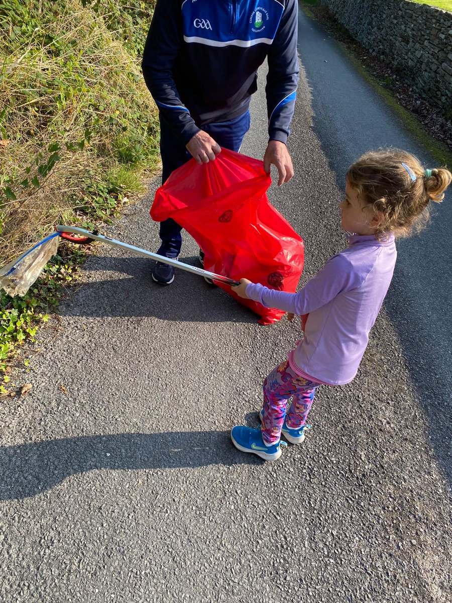 Community Clean Up Day  
Finbarr is getting a helping  hand from his granddaughter Maggie ,cleaning up the parish