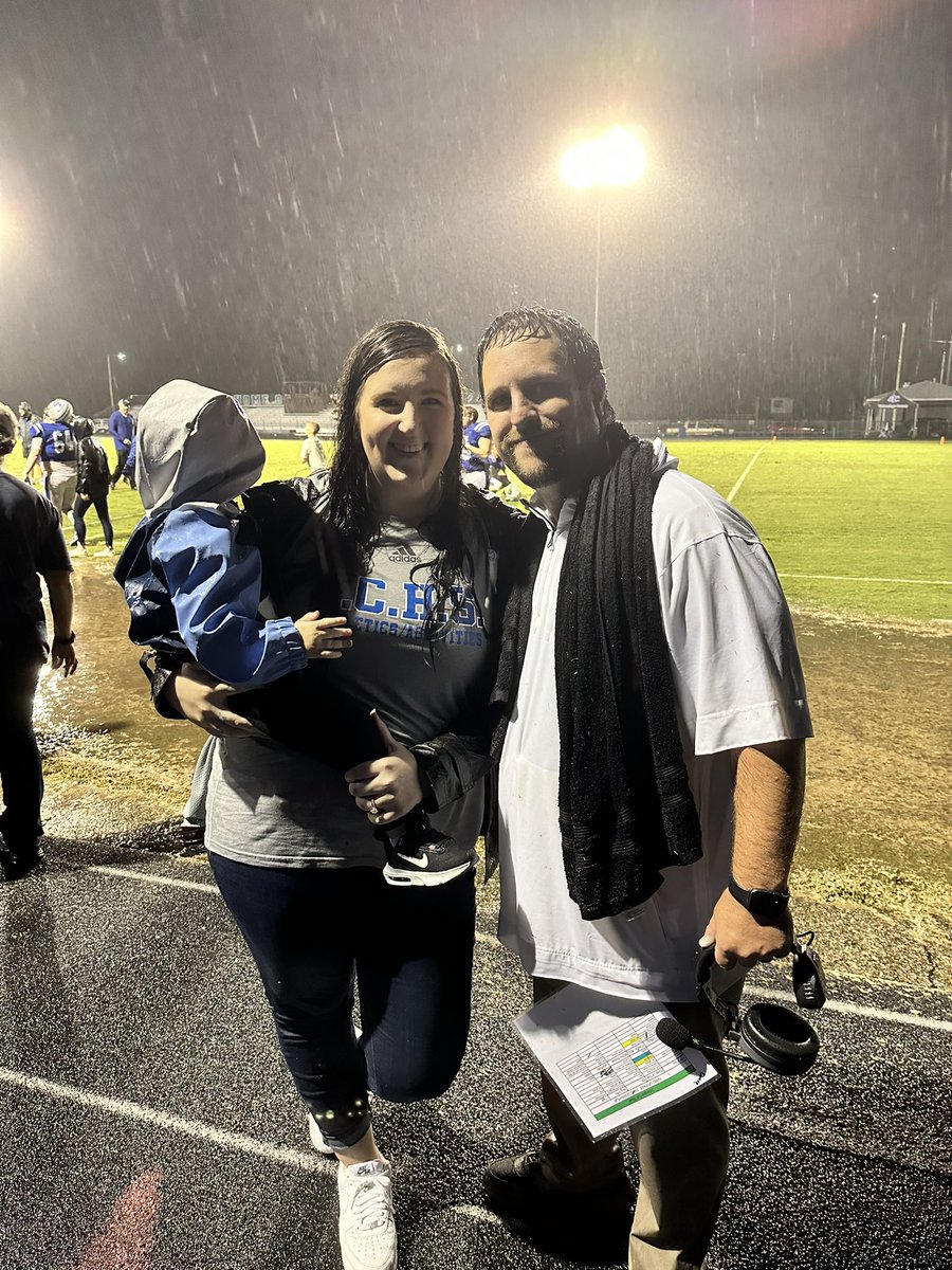 HaleyDance14's tweet photo. We are SOAKED and Wyatt isn’t looking, but first thing Drew said when he saw me was “your makeup hasn’t moved”🤣 the Braves are 3-0!!! So proud 💙🤍 #fridaynightfootball @TheCoachDance https://t.co/3b97GImmbX