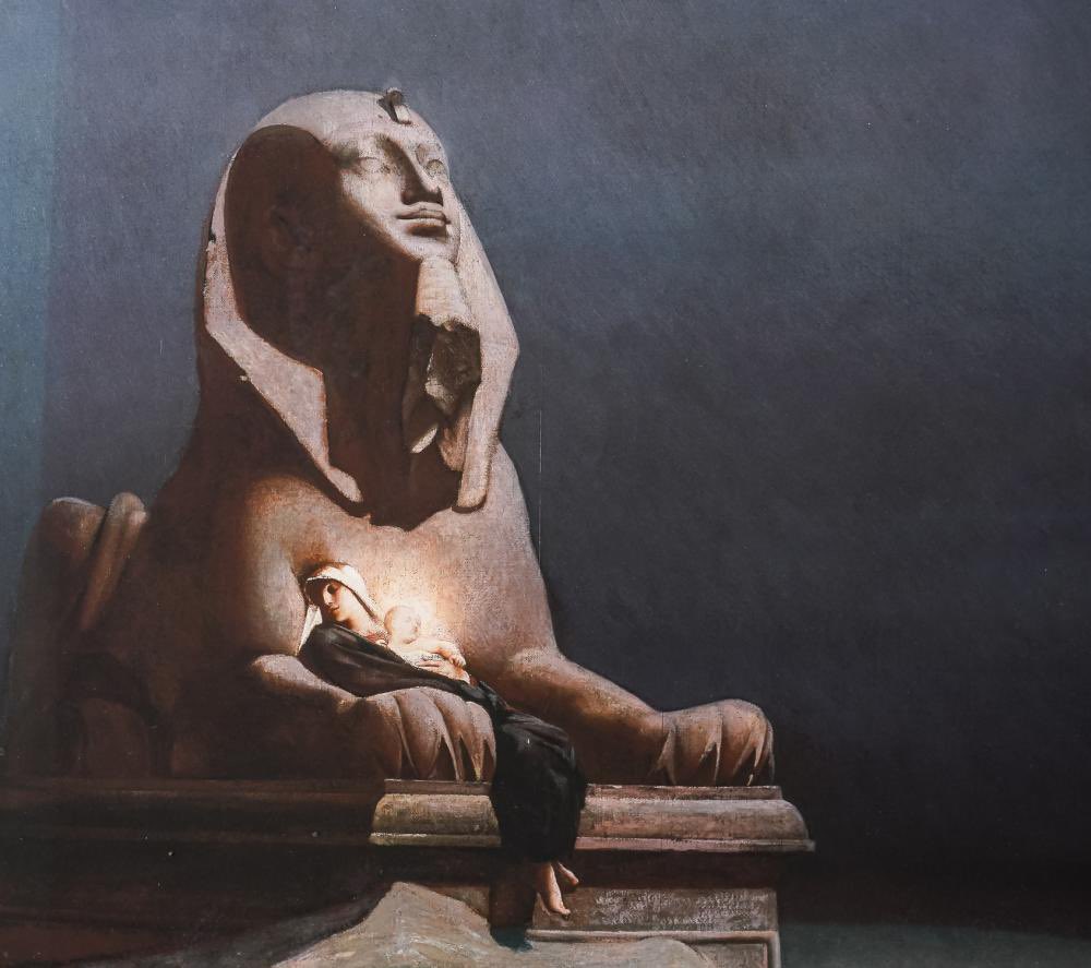 rolvatore's tweet photo. Rest on the Flight into Egypt (1879)
By
Luc-Olivier Merson (1846-1920)

The painting displayed is “Rest on the Flight into Egypt” by French artist Luc-Olivier Merson, completed in 1879. It depicts the Holy Family, with Joseph, Mary, and the Christ Child, during their flight from King Herod’s decree to kill all newborn boys in Bethlehem. The scene is set in a desolate, starlit night, providing a quiet moment of repose against a backdrop featuring an ancient Egyptian sphinx, symbolizing the old religions giving way to the new Christian era.

The central figure of the Virgin Mary, cloaked in a serene blue, rests between the paws of the sphinx, holding the Christ Child, whose divine light illuminates the composition. Joseph is depicted asleep, stretched out beside them. The inclusion of the sphinx adds a layer of historical depth, contrasting the fleeting safety of the family against the permanence and decay of ancient civilizations.

The painting is known for its subdued, moonlit color palette, primarily in blues and grays, creating a contemplative and solemn atmosphere. The use of chiaroscuro enhances the mystical aura surrounding the child, highlighting the divine presence amidst the ruins of the old world.

This artwork, held in high regard for its symbolic depth and artistic execution, represents a significant piece of Merson’s oeuvre, showcasing his blend of historical and religious themes rendered with academic precision. It reflects both a spiritual and cultural journey, bridging diverse epochs and geographies through its evocative use of Christian and ancient Egyptian iconography.