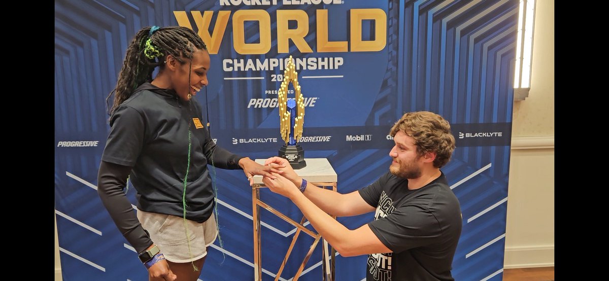 MrJamminJoey's tweet photo. We’re ENGAGED! 💍❤️ I popped the question in front of the trophy at Worlds! 🏆💙 I am grateful for this game and excited for our next chapter! 🚀💫 #RocketsEngaged @PsyonixStudios @RocketLeague https://t.co/ARYG96YooX