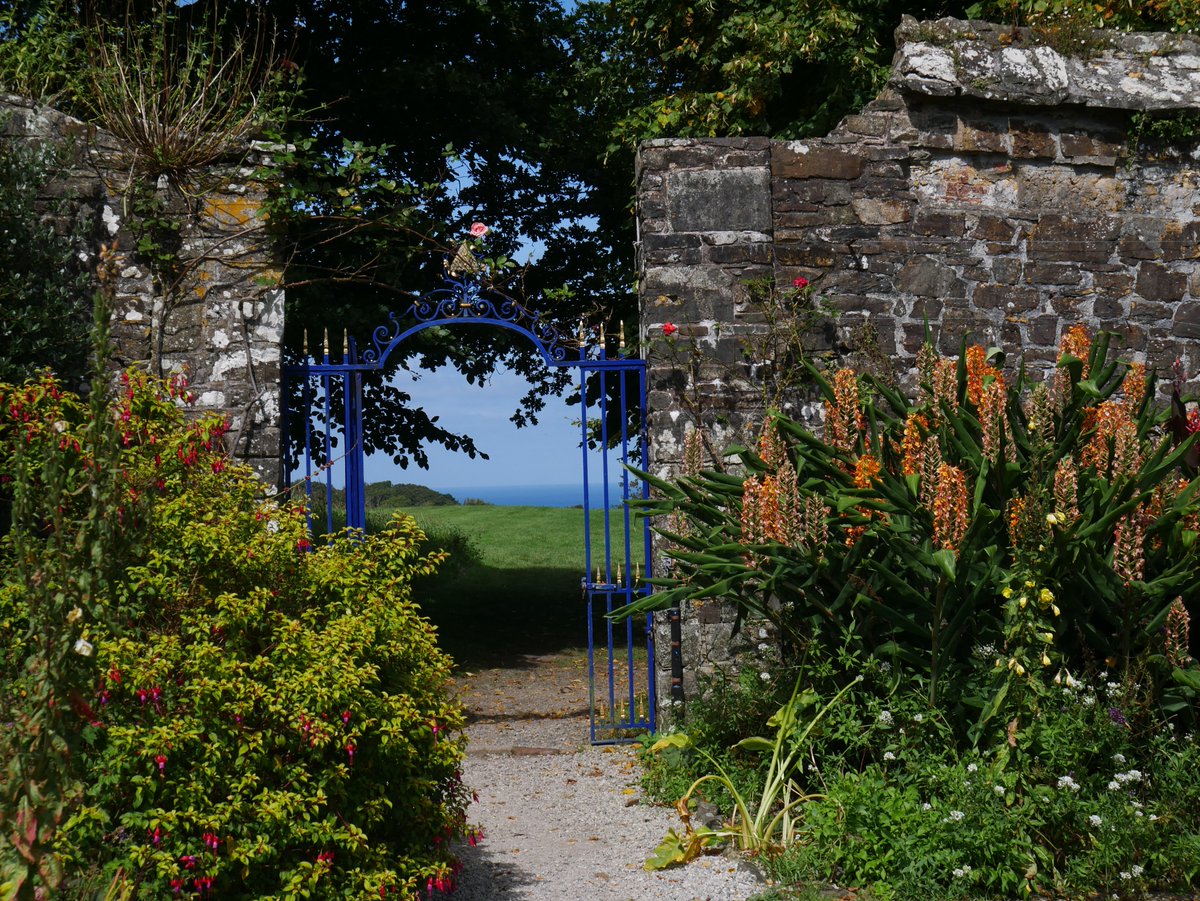 Walled garden of Clovelly Court &amp; its lean-to greenhouses, with its sheltered position overlooking the Bristol Channel. Just one of a number of stunning North Devon Gardens open to visitors.