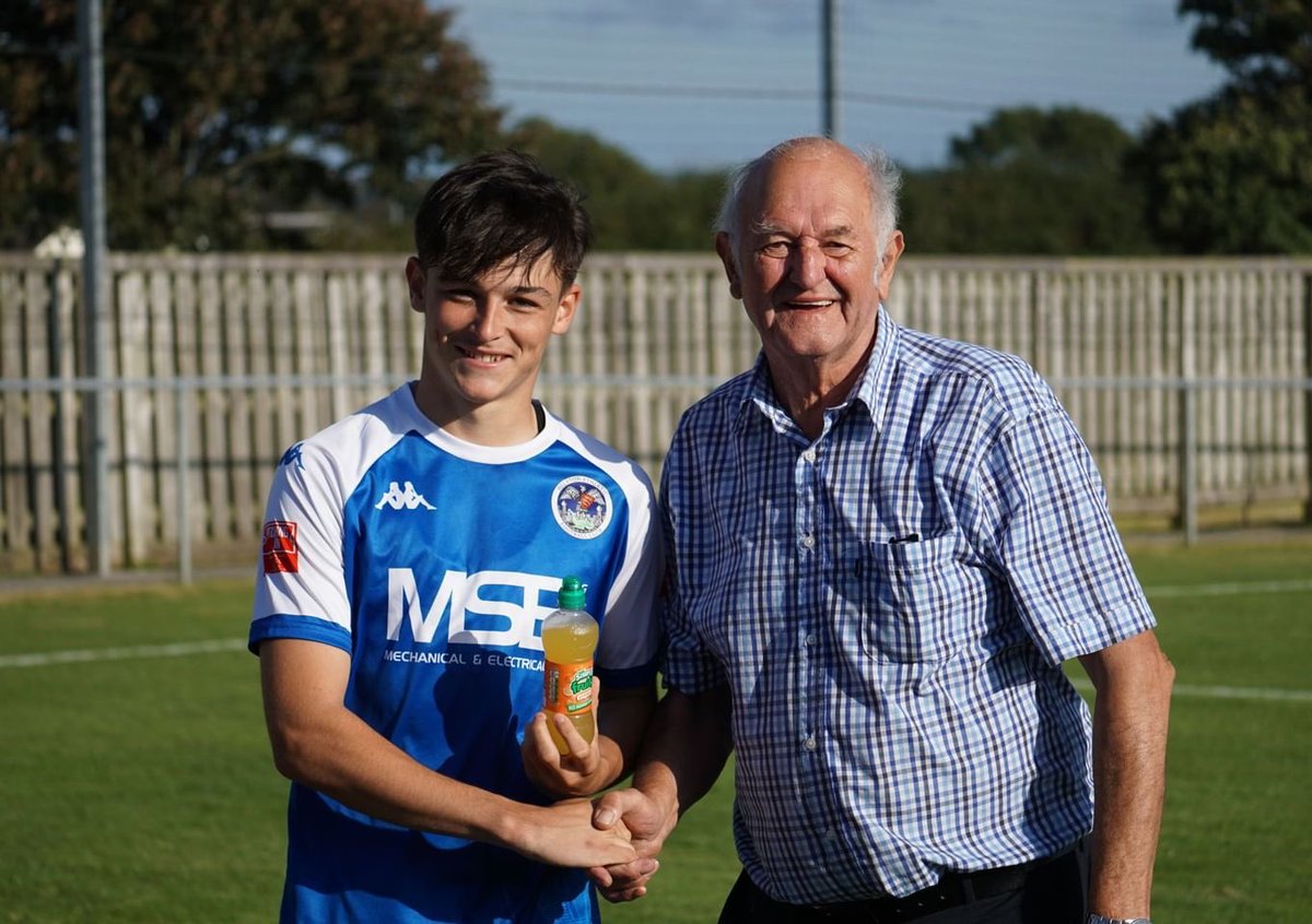 HelstonAFC's tweet photo. Yesterday’s MOTM against Bideford was @dylanmitchell06 , making his full debut at  centre back, with a performance that belied his youth. 

Here he is receiving his award from VP Barry Dunstan, and his family receiving the champagne on his behalf.

📸- https://t.co/pCLnIl5NE4 https://t.co/tqlBgmtT3b