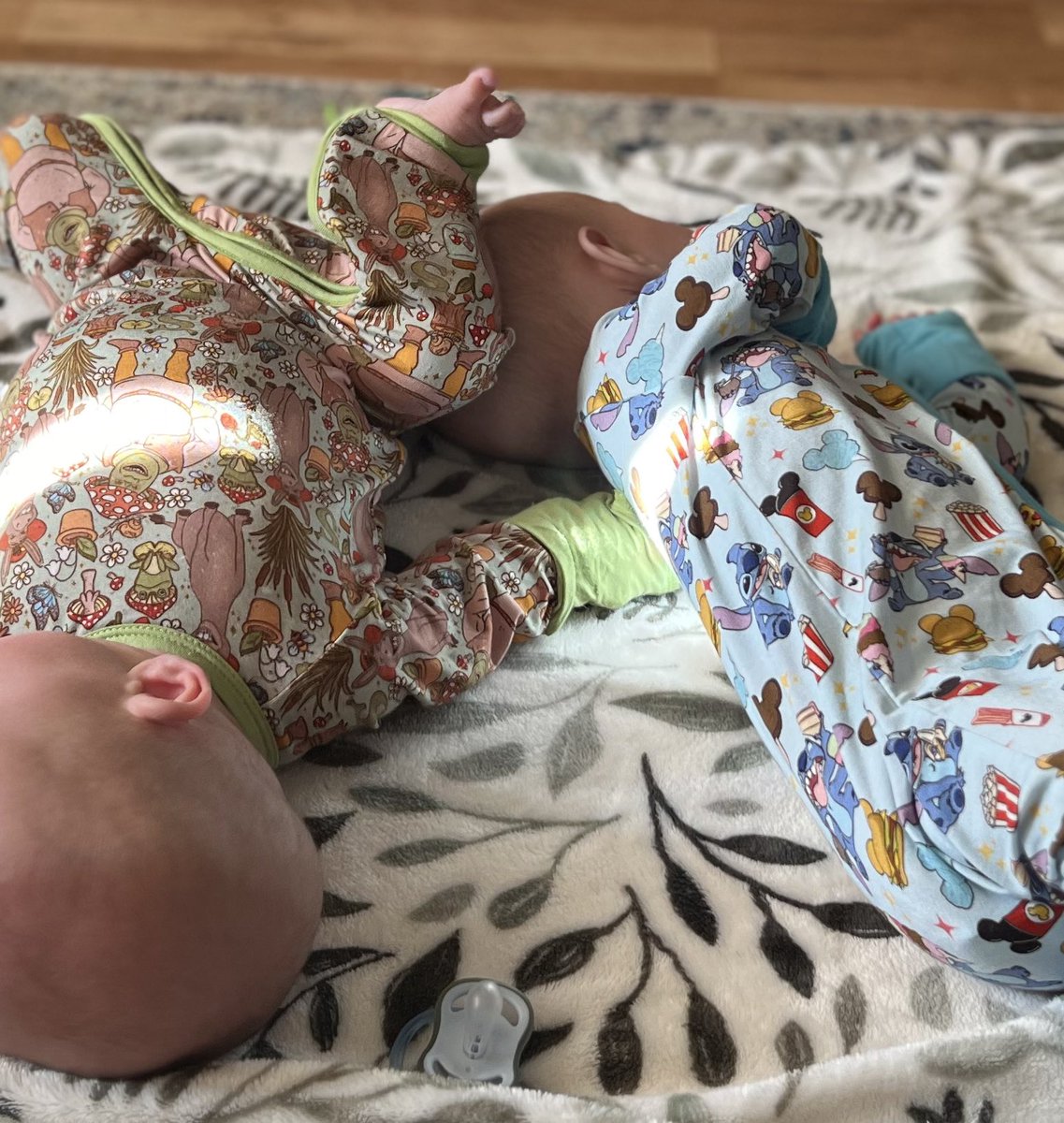 LoudasaurusRex's tweet photo. E (in the Shrek pajamas) has a meltdown if L so much as touches her bottle, but this is how she is insisting on laying right now 😂 https://t.co/lsYpoyLGcp