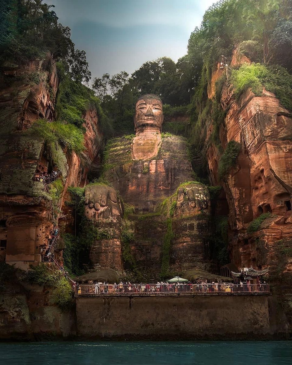 Giant Buddha, Leshan, China. Carved out of a cliff face between 713 and 803 CE. It is 71 meters tall and, to get a sense of scale, the top of each shoulder is the size of an NBA basketball court. The statue depicts Maitreya, the embodiment of all-encompassing love.