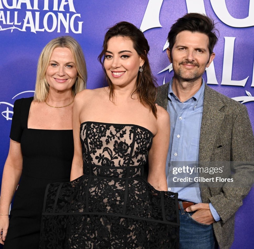 they look like proud parents posing with their theater kid after her play before heading off to dinner at a local red lobster