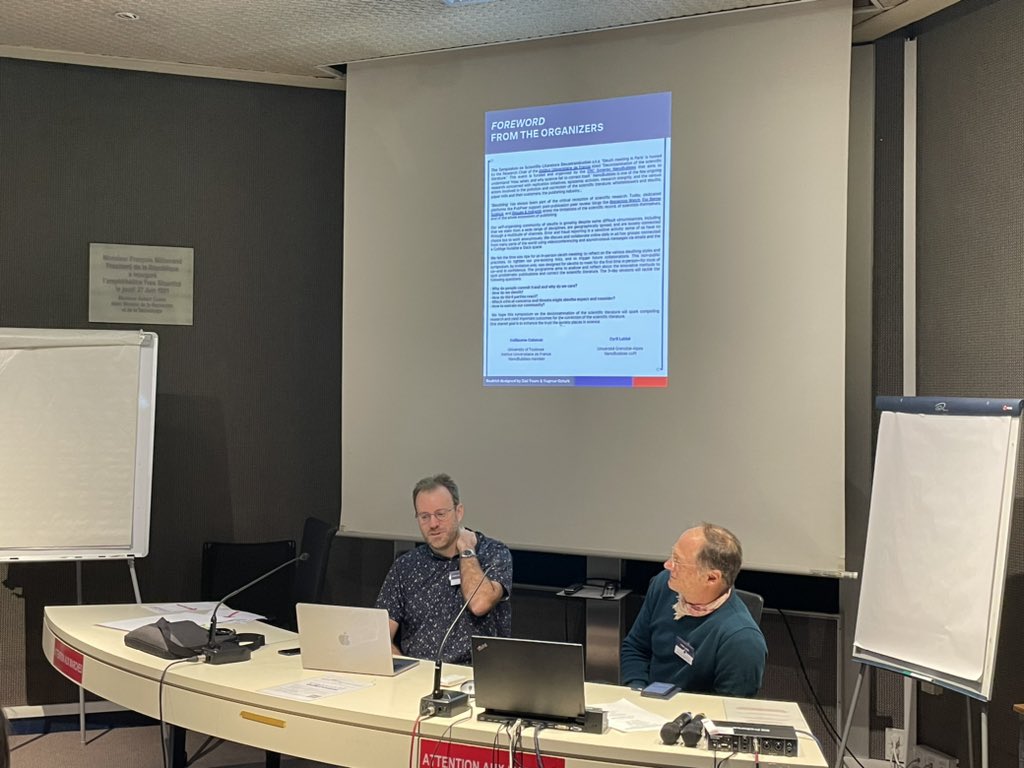 Opening the Symposium on Scientific Literature Decontamination by <a href="/gcabanac/">Guillaume Cabanac ⟨here and elsewhere⟩</a> and Cyril Labbé, with a room full of sleuths and science critics, somewhere in Paris.