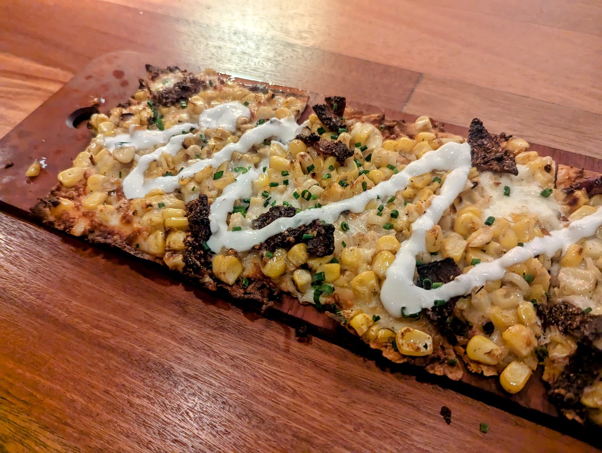 Bacon, corn and cheese on flatbread. First time I've ever had this, it was a tasty appetizer.