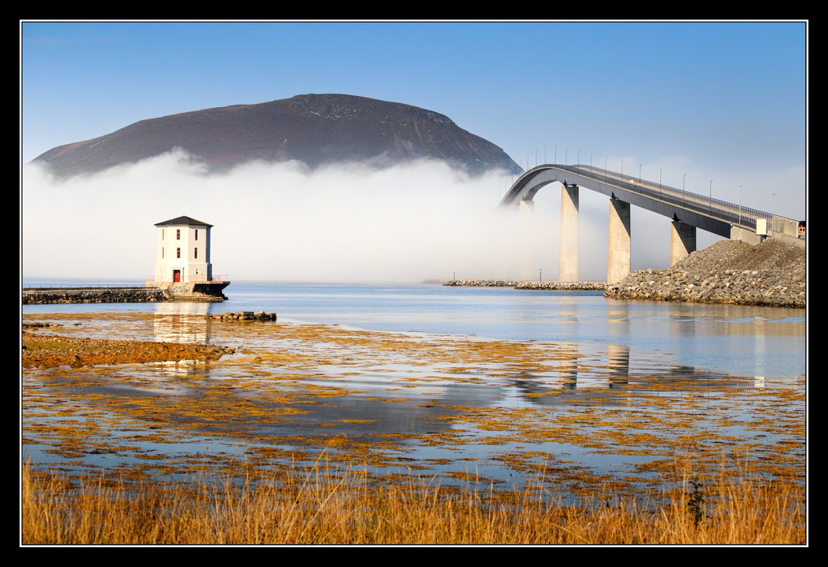 Lepsøybrua is a relatively new bridge, opening at the end of 2021. It rises to 41m above the sea and the longest span is 155m, with a total length of 800m.

As you can see, I picked the perfect day to photograph it as the fog danced around the piers.