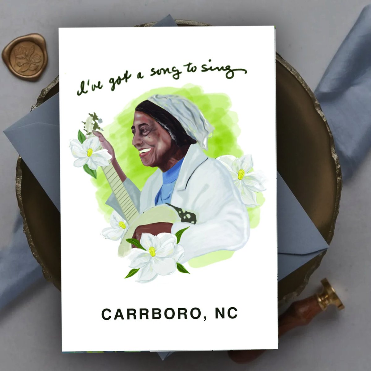 CardMuses's tweet photo. Celebrate World Postcard Day with us at My Muses Card Shop. In honor of Carrboro’s own Libba Cotten we’re sharing exclusive postcards featuring the musical icon behind "Freight Train" Take home a piece of her legacy, one postcard at a time #WorldPostcardDay #LibbaCotten #Carrboro https://t.co/i7gygINcJm