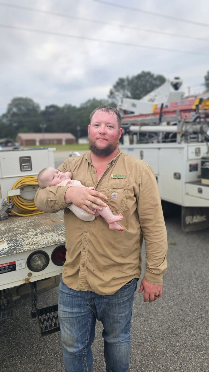 SCcooperatives's tweet photo. Meet Graham Hennessey from York Electric Co-op, holding his 2-month-old daughter, Madelyn. During #HurricaneHelene, Graham and linemen like him are working tirelessly to restore power, sacrificing time with family to serve their community.

@yec_cooperative https://t.co/YPVzDkQbvG