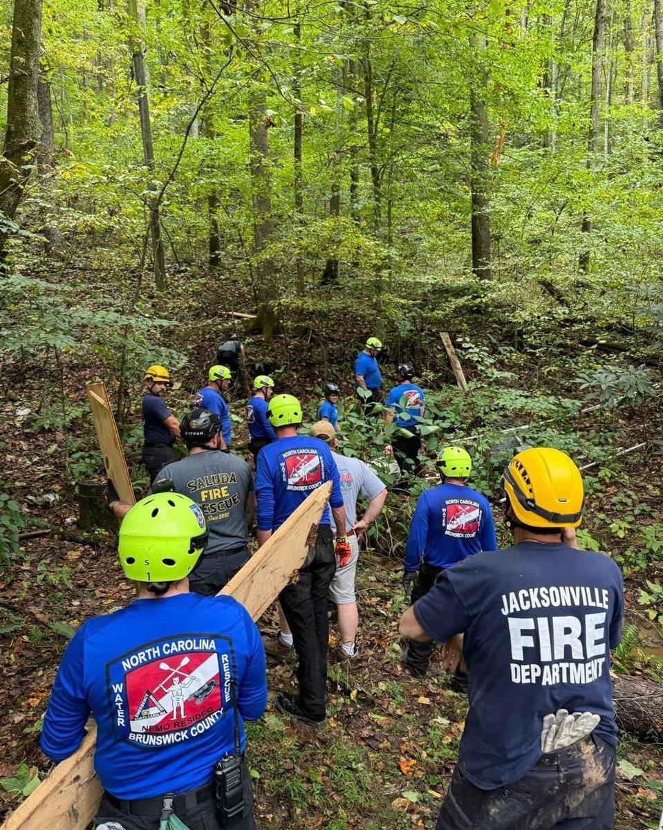 Huggins2687's tweet photo. From North Carolina Weather Authority: 

Rescue workers are working to reach the most remote areas. Here are rescue workers trying to find people in Polk County. The roads have been completely wiped out, so the only way to some locations is to hike. Thank you, first responders, for your amazing work. 
Photos: Saluda Fire and Rescue.
