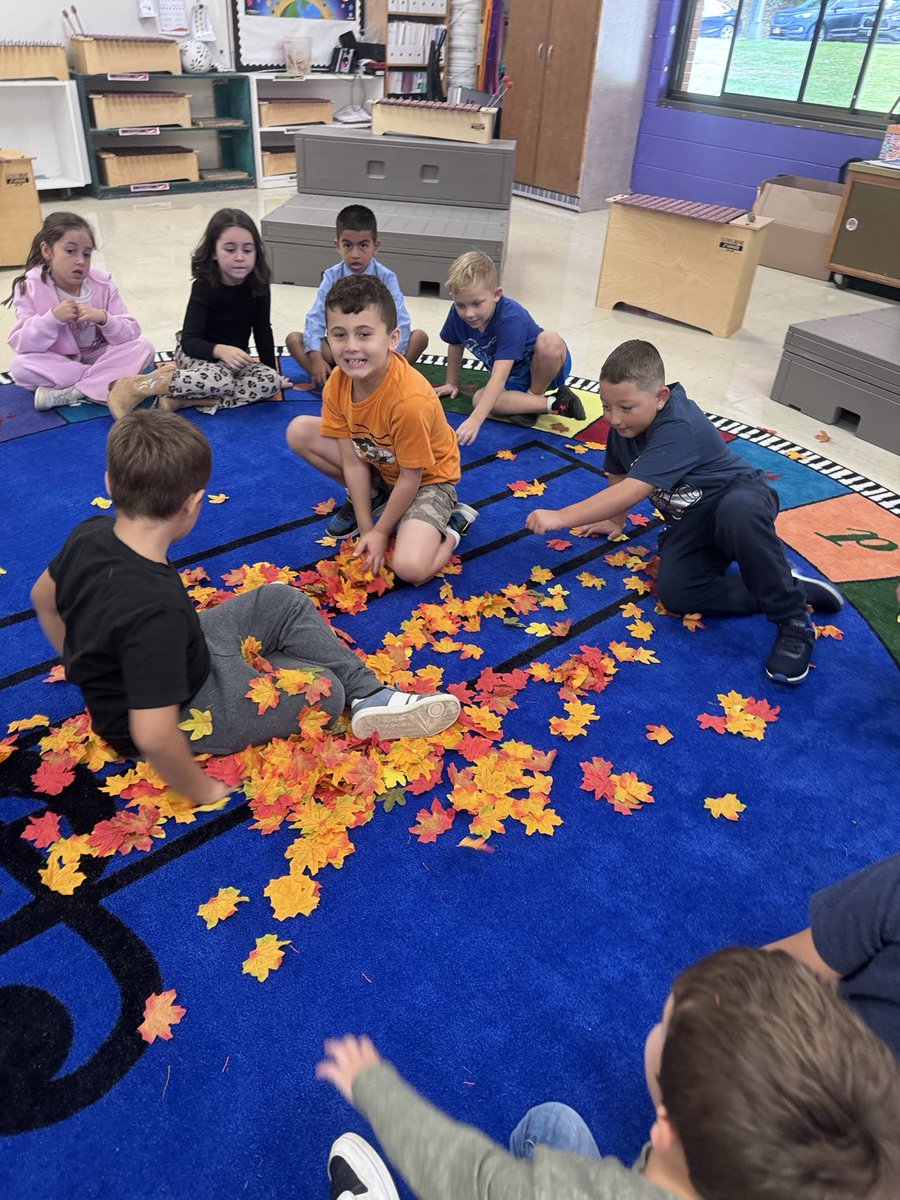 FulmarRdMusic's tweet photo. Yellow red and brown, leaves gently falling down. 2nd graders had a blast piling up leaves and jumping in.. on our awesome new rug! @Fulmarsfinest https://t.co/TfSWS2BWZL