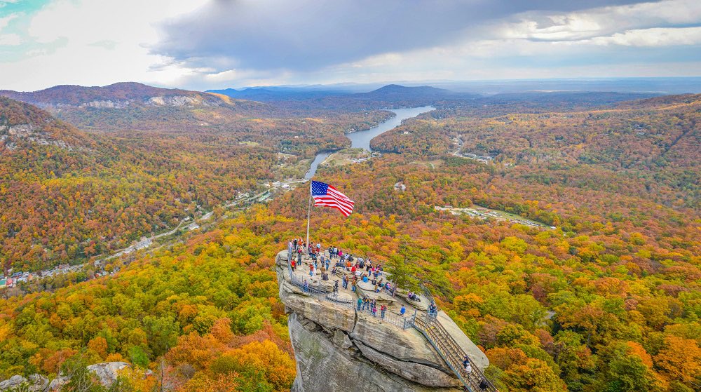 A State Parks team has reached and raised old glory atop Chimney Rock, NC in the storm aftermath